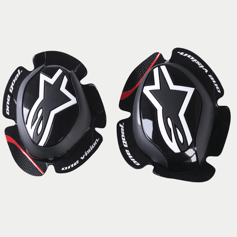 Alpinestars GP Pro Knee Sliders, Black, featuring white Alpinestars star logo, 'one goal. one vision.' text on the edges, red accent stripe on textured wings, anatomically shaped polymer compound for motorcycle racing gear