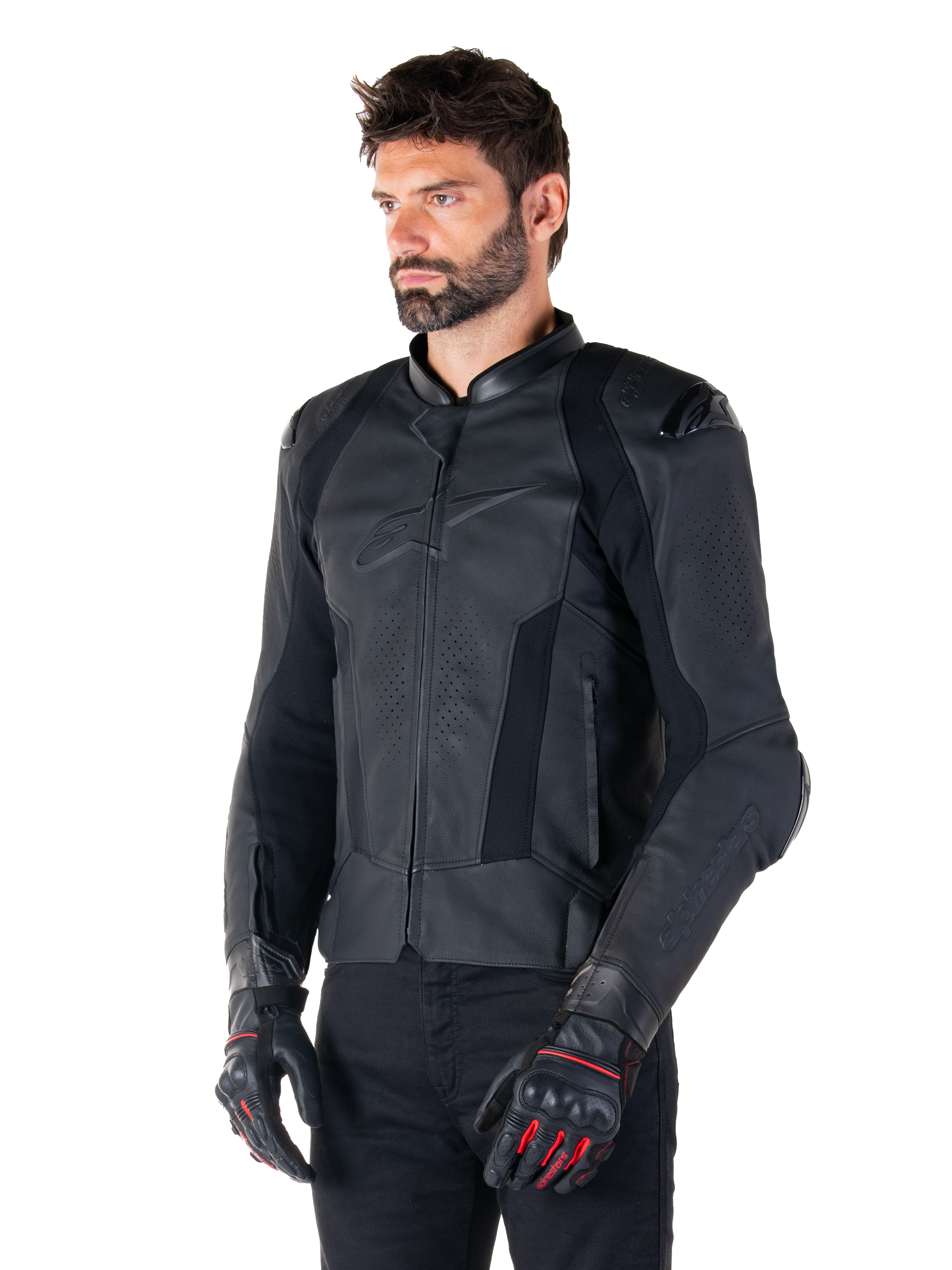 Male rider wearing the Alpinestars Missile V3 Leather Jacket in Black, premium bovine leather with perforated chest panels and external DFS shoulder protectors, paired with black pants and black/red racing gloves.
