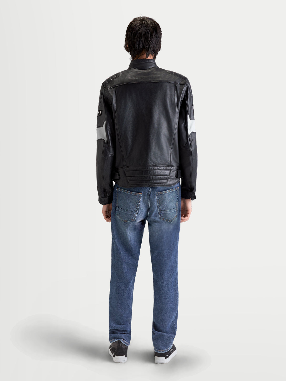 Alpinestars Revern Lederjacke, urbane Motorrad-Lederjacke für Herren in Schwarz und Metallgrau, Rückansicht an einem Model in Jeans, die hochwertiges Rindsleder zeigt