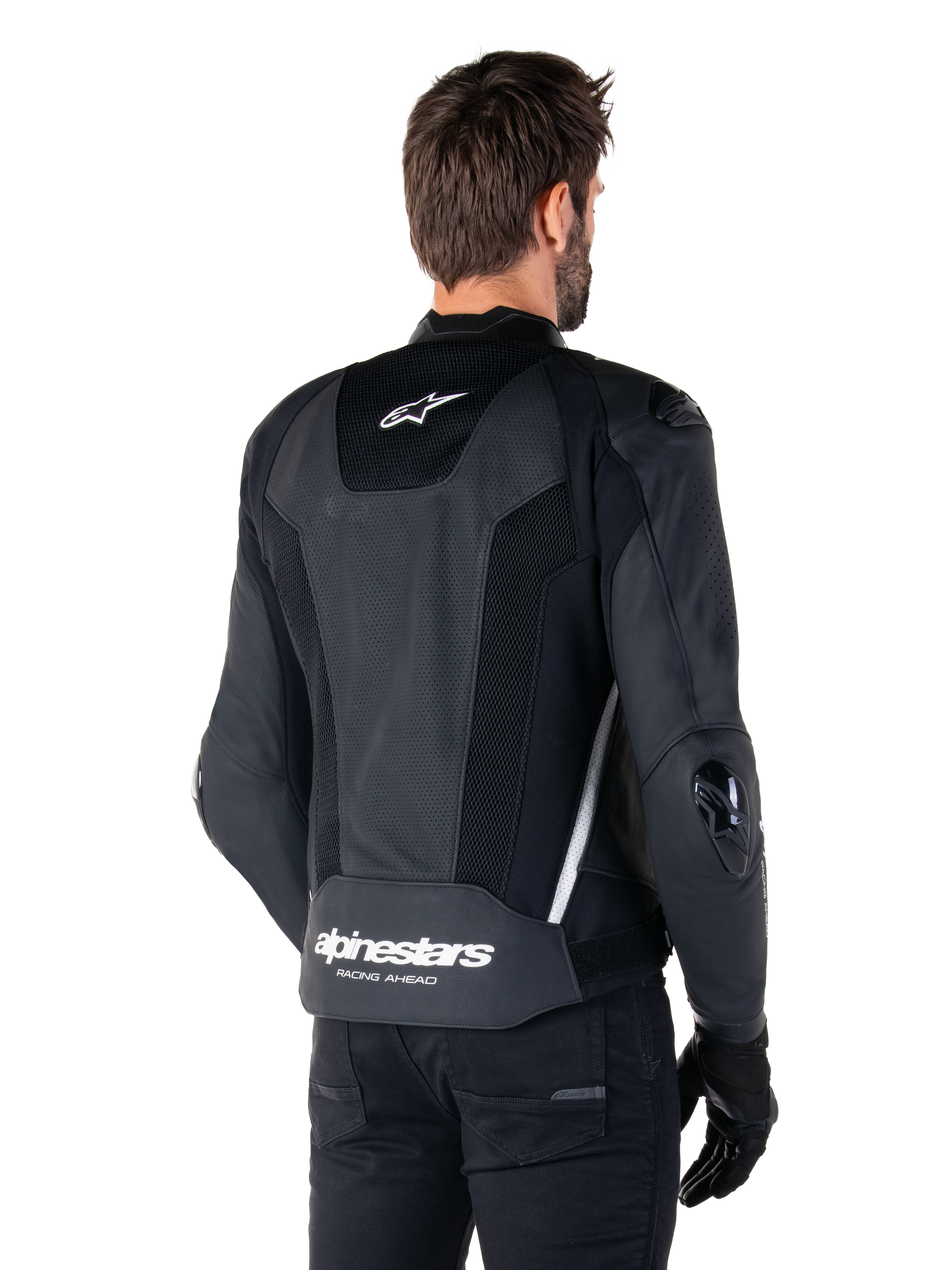 Alpinestars Missile V3 Airflow Leather Jacket, Black and White, rear view featuring perforated leather and mesh panels for maximum ventilation, white Alpinestars branding on lower back and star logo on neck, worn with black riding gear, premium racing sport design.