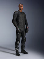 Male model wearing the Alpinestars Dusk Leather Jacket in Black Laser, paired with matching black leather racing pants, GP Pro gloves, and performance track boots. Full motorcycle racing gear with external DFS shoulder protection and a sleek athletic fit for sport and road riding.