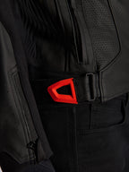 Alpinestars GP Plus R V4 Airflow Leather Jacket close-up, black perforated leather with a vibrant red fluo hook-and-loop waist adjustment strap, featuring a zippered side pocket and ergonomic textured panels.