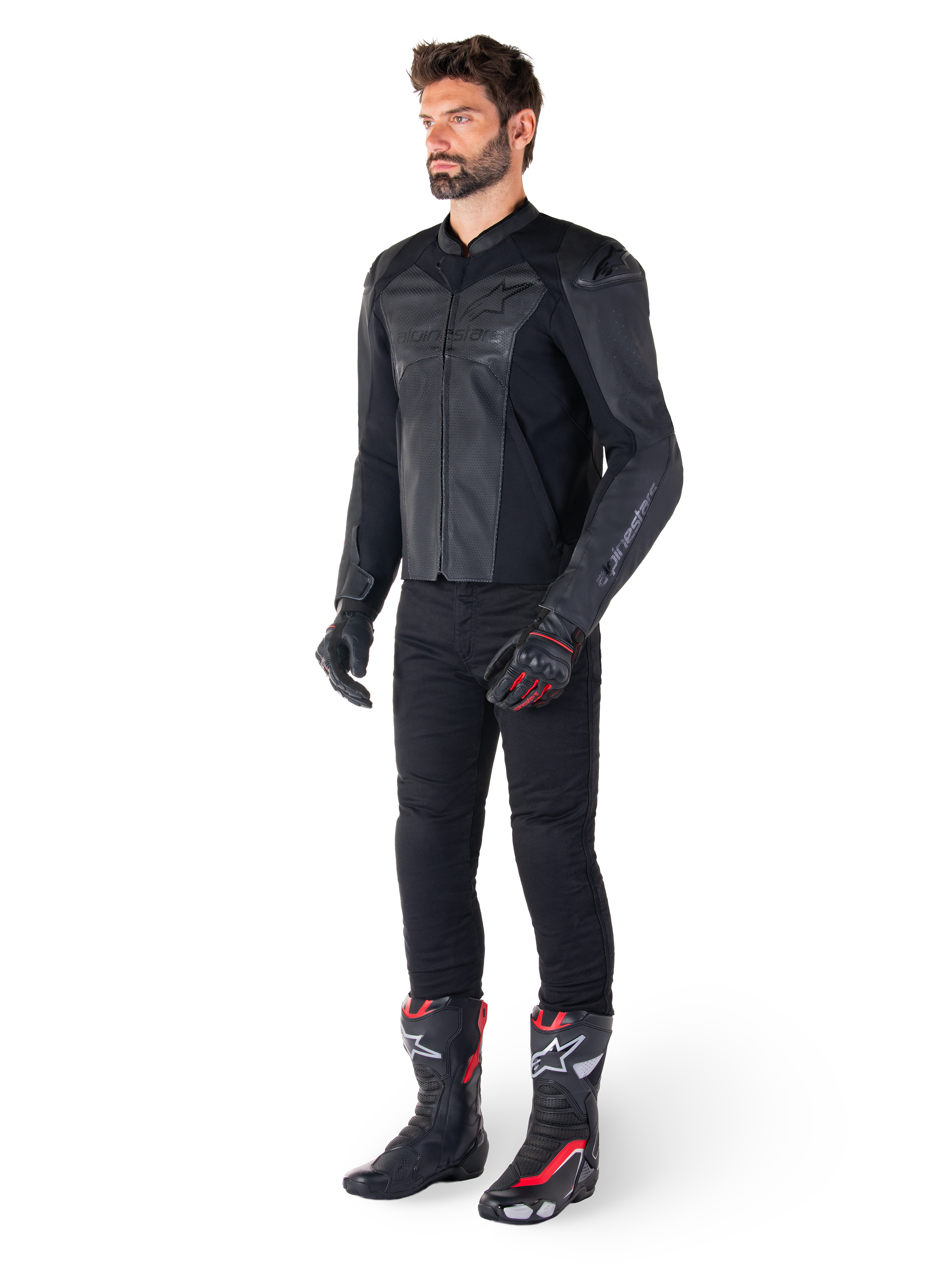 Man wearing Alpinestars Faster V3 Airflow Leather Jacket in Black Black, paired with black pants, black and red motorcycle gloves, and black racing boots with red and white accents, full-body sport riding gear