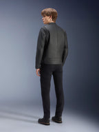 Alpinestars Dyno Leather Jacket, Black, worn by a male model from the rear view, featuring ribbed shoulder panels, paired with black pants and boots, heritage-inspired urban motorcycle style.