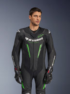 Alpinestars GP Force V2 Leather Suit - 1Piece, Black and Green motorcycle racing suit, worn by model, featuring perforated leather panels, bold white Alpinestars branding on chest and sleeves, and integrated shoulder protection for track performance.