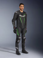 Alpinestars GP Force V2 Leather Suit 1-Piece, Black and Green, full racing gear worn with black gloves and boots, featuring perforated leather panels, white Alpinestars branding, and integrated knee sliders, professional track performance suit