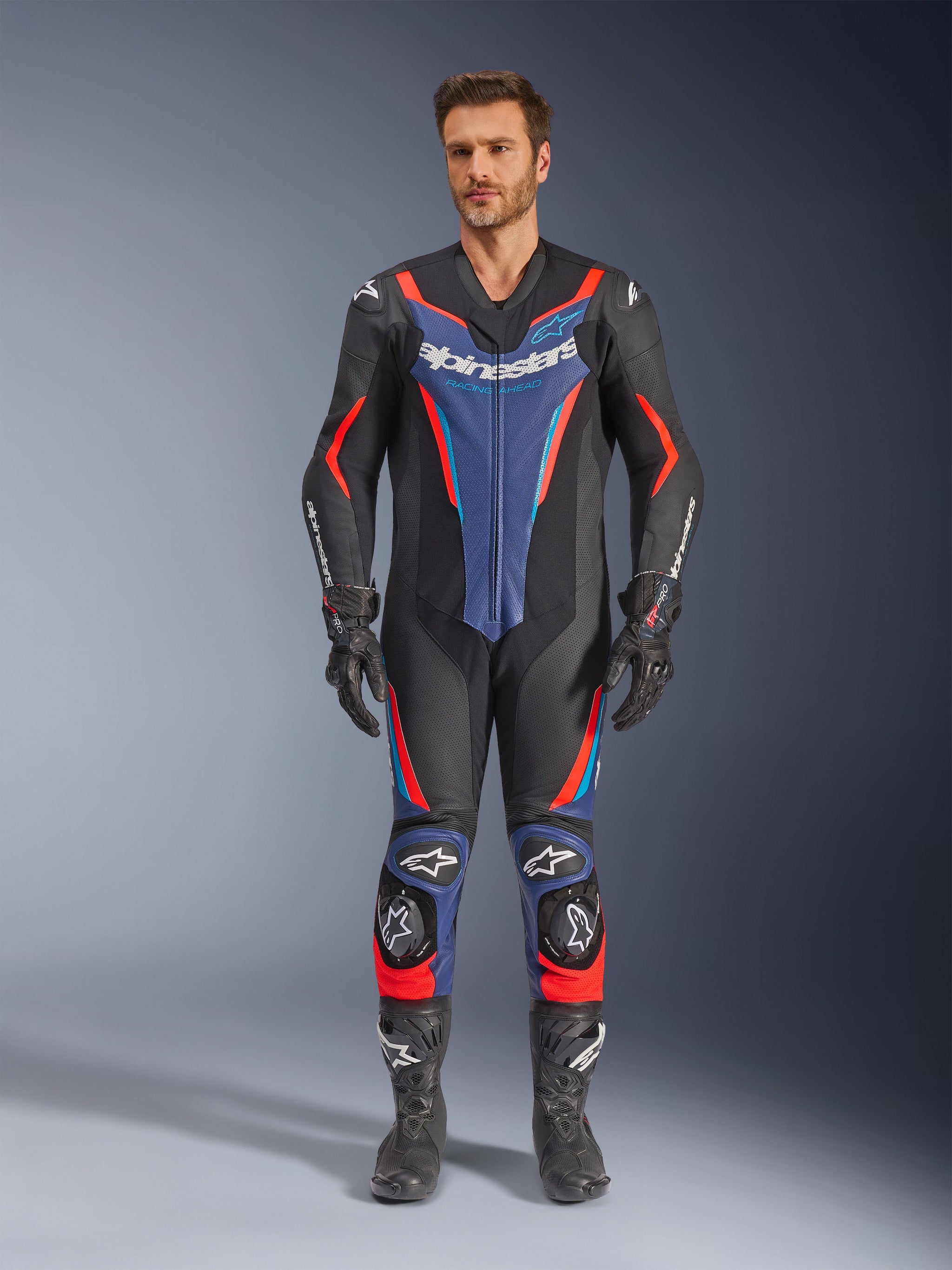 Alpinestars GP Force V2 Leather Suit, One-Piece Motorcycle Racing Suit, Black Red and Blue, Full-Body View with Rider, CE Certified Protection, Aerodynamic Design with Reinforced Shoulders Elbows Knees and Shins, Premium Leather Construction