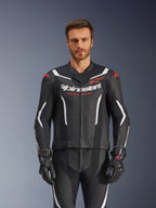 Alpinestars GP Force V2 Leather Suit- 2Piece, Black White and Red Fluo, front view of male model wearing the perforated leather suit with matching black gloves, featuring white angular accents and Alpinestars branding on the chest