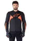 Alpinestars T-Jaws V4 Waterproof Jacket, Motorcycle Sport Jacket, Black and Red Fluo, featuring neon accents and a prominent star logo on the chest, worn by a male model with black riding gloves, sleek racing-inspired textile design