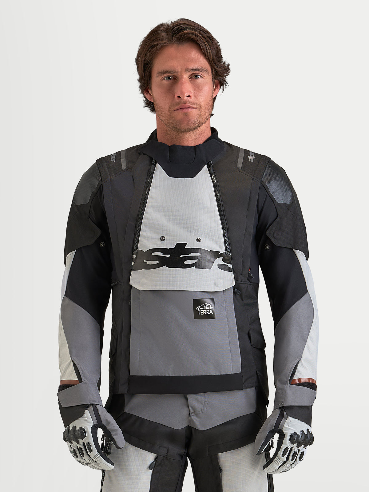 Alpinestars Harok V2 Drystar Jacket, Men's adventure motorcycle jacket in dark gray, ice gray, and black, featuring modular ventilation, waterproof construction, and CE certification worn by a model