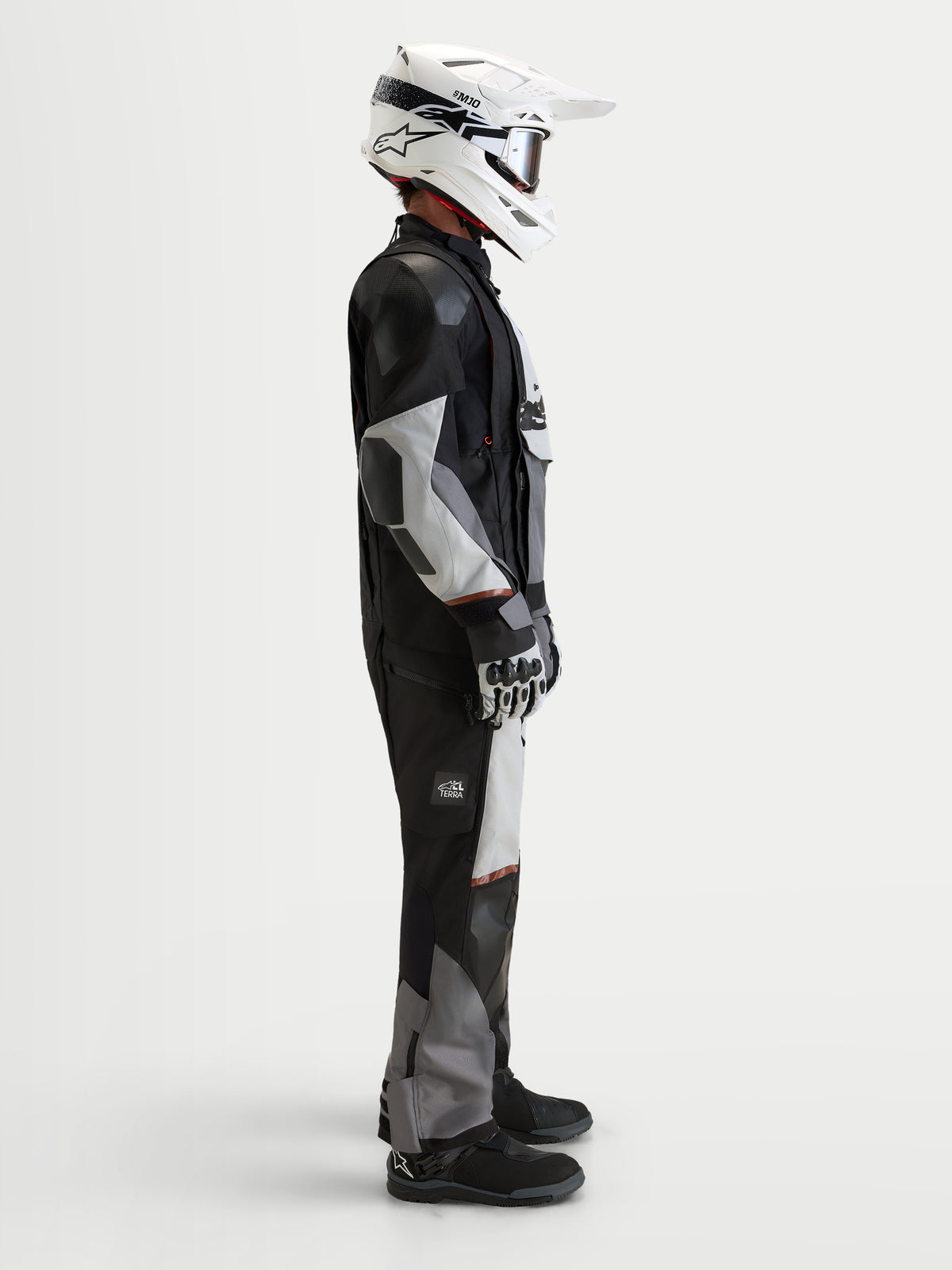 Alpinestars Harok V2 Drystar Jacket, men's all-terrain adventure motorcycle jacket, Dark Gray, Ice Gray, and Black, worn with a white helmet and adventure riding gear in a studio side view