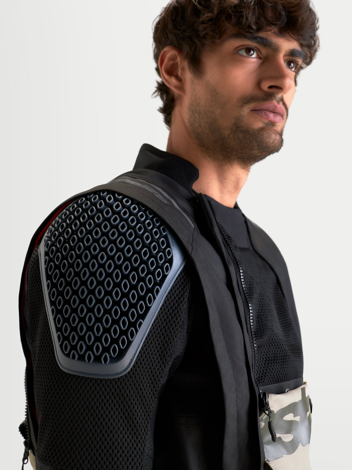 Alpinestars Harok V2 Drystar Jacket, men's all-terrain adventure motorcycle jacket in aluminum, walnut, and black, close-up showing integrated Nucleon Flex Pro CE Level 2 shoulder armor and modular mesh ventilation chassis