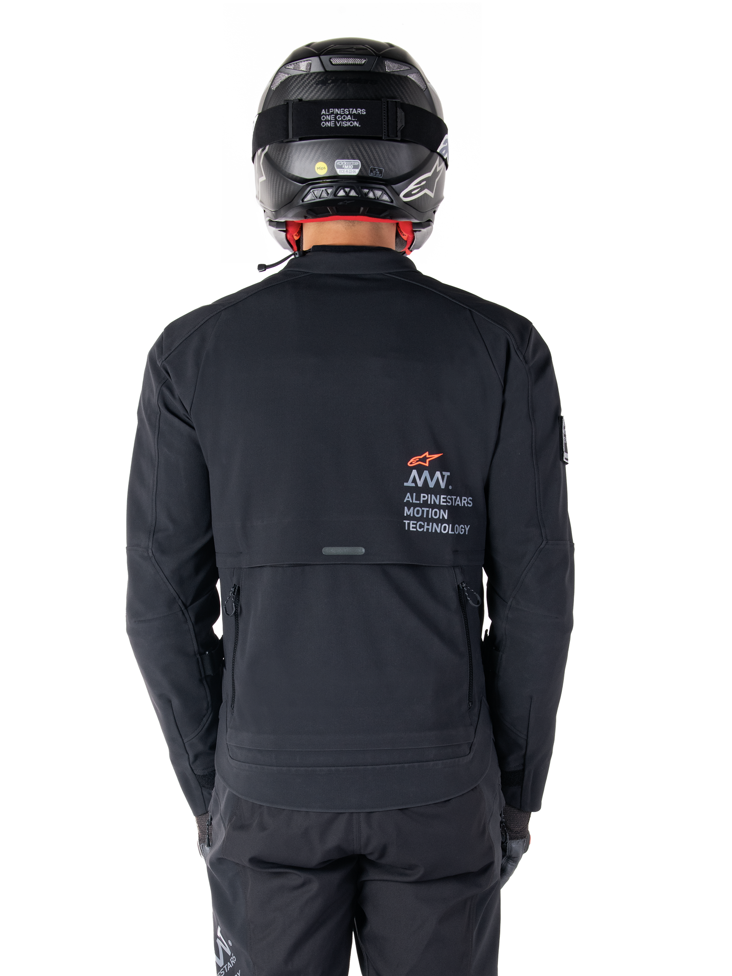 Alpinestars AMT-8 Stretch Drystar® XF Jacket, Rear View, Black, worn with a black helmet and pants, featuring Alpinestars Motion Technology branding on the back, adventure touring design with ergonomic stretch material.
