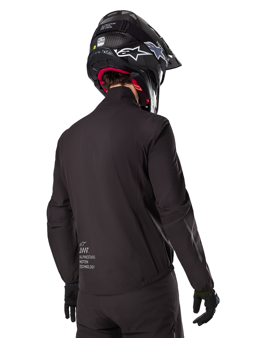Alpinestars AMT-8 Stretch Drystar® XF Liner, Black Waterproof Jacket Liner, rear view on a rider wearing a black helmet and gloves, featuring Alpinestars Motion Technology branding on the lower back, minimalist and functional design for adventure riding.