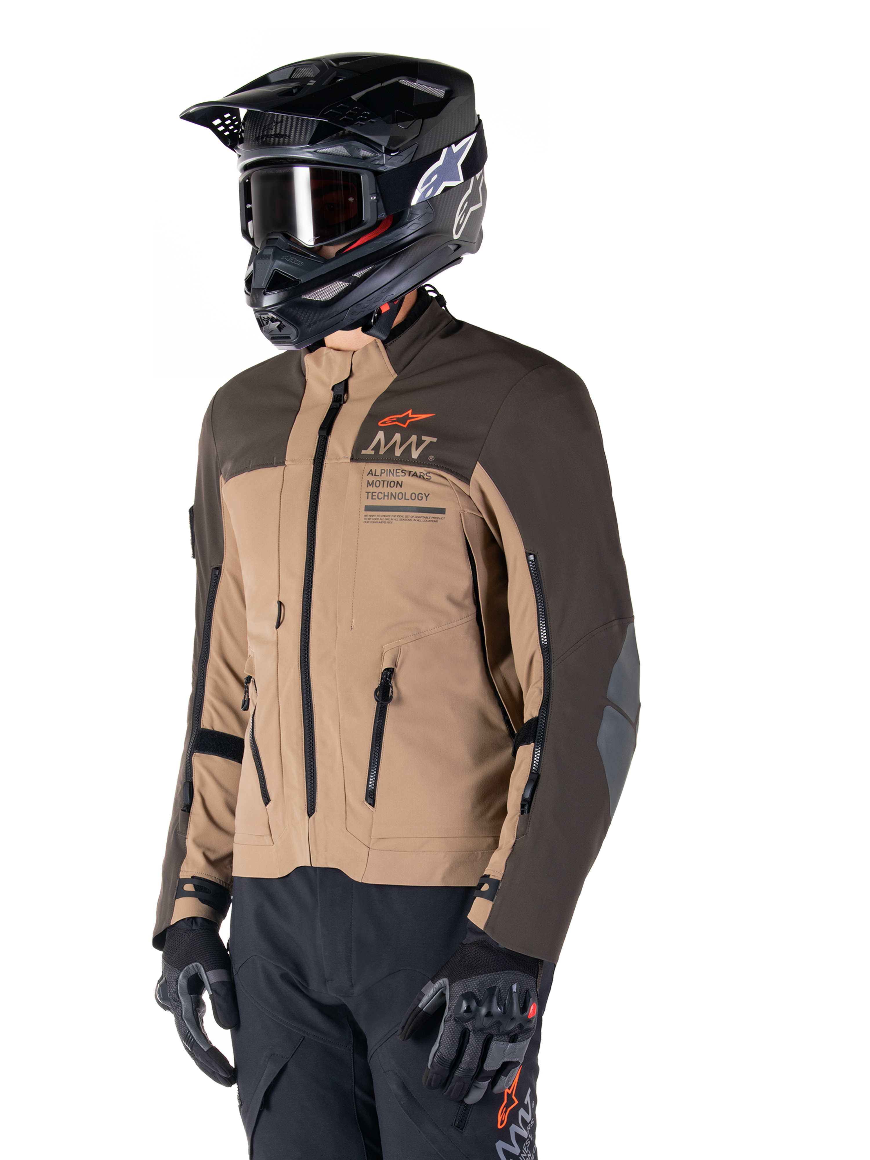 Alpinestars AMT-8 Stretch Drystar® XF Jacket, Adventure Motorcycle Jacket, Dark Brown and Dark Khaki, worn with a black off-road helmet and goggles, featuring Alpinestars Motion Technology branding and zippered ventilation ports.