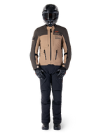 Alpinestars AMT-8 Stretch Drystar® XF Jacket, Adventure Motorcycle Jacket, Dark Brown and Dark Khaki, worn with a black helmet, goggles, black gloves, black pants, and black boots, featuring chest ventilation ports and AMT branding, coordinated gear for adventure touring