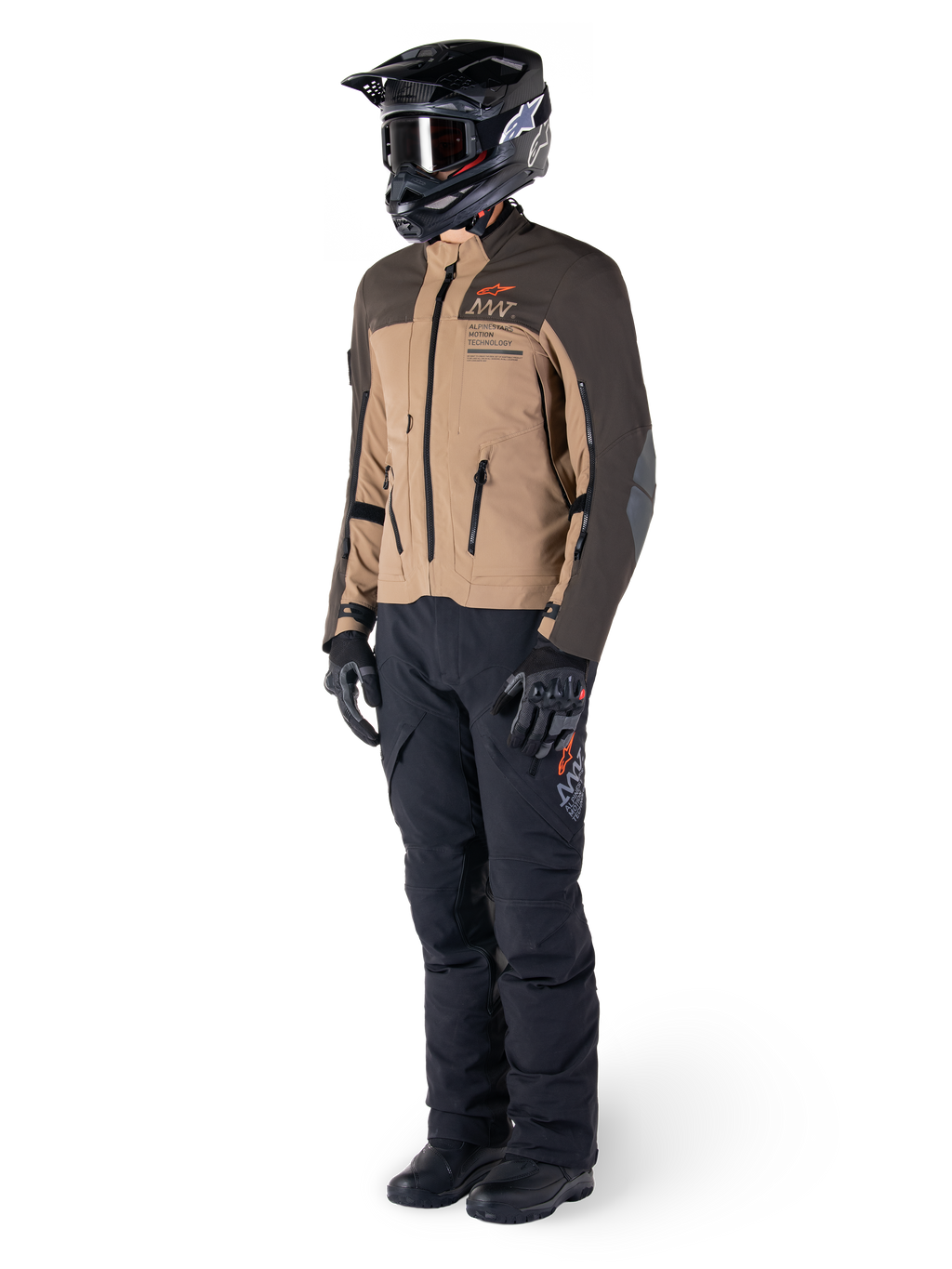 Adventure rider wearing complete gear, Alpinestars AMT-8 Stretch Drystar® XF Jacket in Dark Brown and Dark Khaki, paired with black adventure pants, black helmet, gloves, and boots, featuring orange AMT branding and technical ventilation zippers for long-range touring