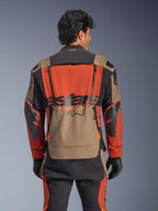 Alpinestars Halo Pro Drystar® XF Laminated Jacket, Walnut Rust Black colorway, rear view, featuring a large orange back panel with black ASTARS branding, walnut lower storage pocket, and Tech-Air® Ready collar, worn with matching adventure riding pants and black gloves