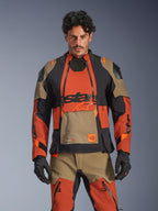 Alpinestars Halo Pro Drystar XF Laminated Jacket, Adventure Motorcycle Touring Jacket, Walnut Rust and Black with Tan accents, worn by a model with matching gear, front view, featuring waterproof laminated construction and modular chest ventilation panels, premium all-terrain riding gear
