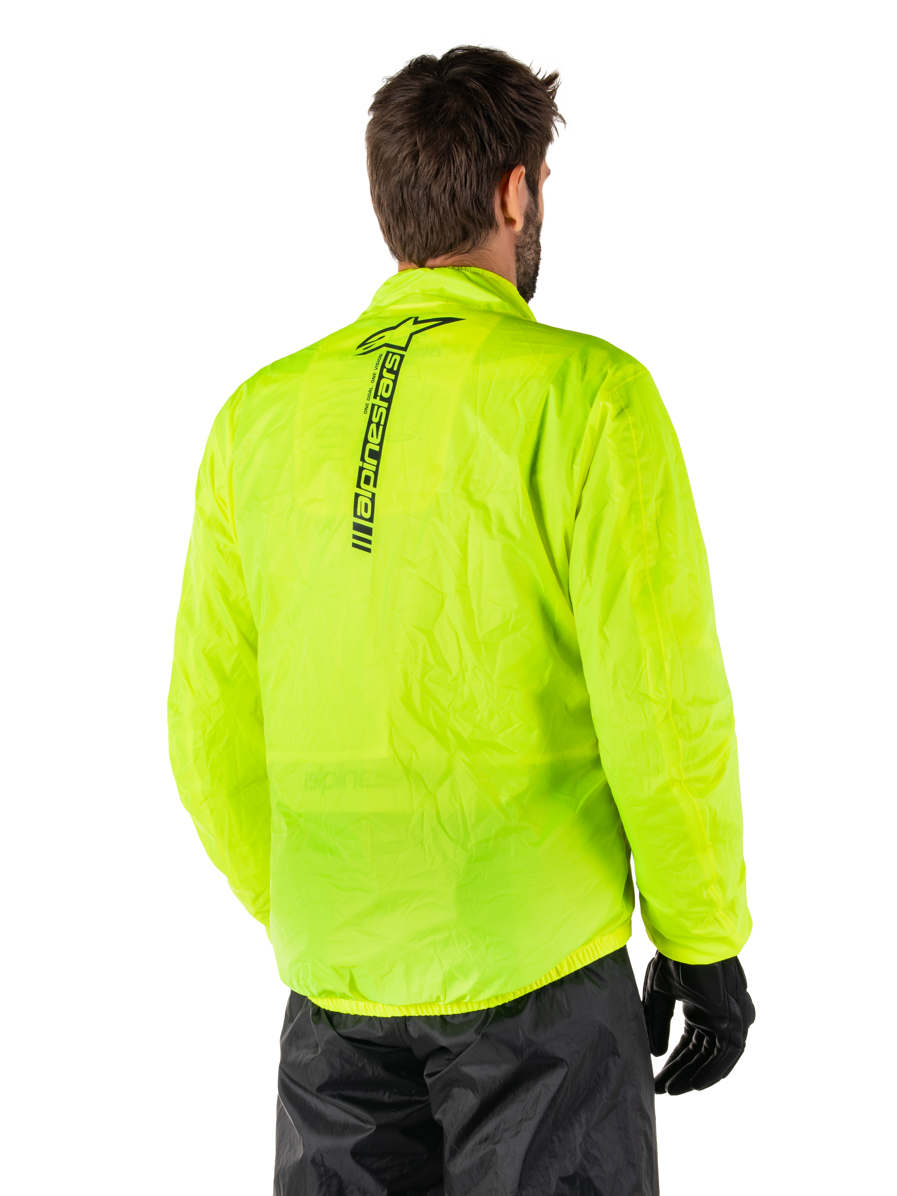 Alpinestars Hurricane Rain V2 Jacke, Gelb Fluo, Rückansicht an einem männlichen Model, vertikale schwarze Alpinestars-Wortmarke auf dem Rücken, elastischer Bund und Ärmelbündchen, wasserdichtes und packbares Design