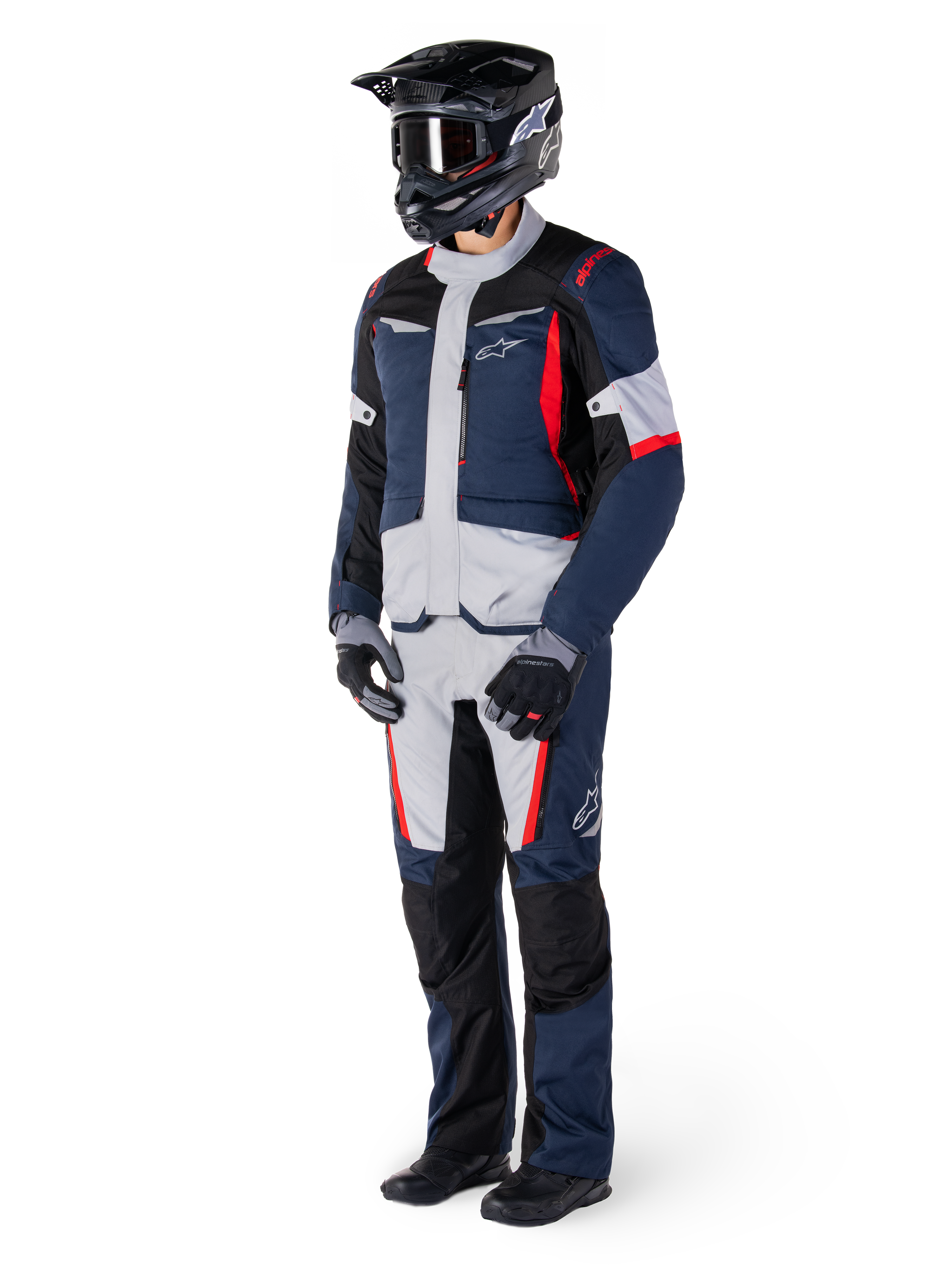 Alpinestars ST-1 Waterproof Jacket, Adventure Touring Jacket, Dark Blue Black and Bright Red, worn by a rider with matching pants, black adventure helmet, gloves, and boots, featuring grey panels and red accents, streamlined adventure-inspired design with Alpinestars logos