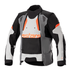 Alpinestars Halo Drystar® Jacke, Motorrad-Adventure-Touring-Jacke, Dunkelgrau, Eisgrau und Schwarz mit orangefarbenen Akzenten, asymmetrischer Belüftungseinsatz vorne, orangefarbenes Astars-Branding, verstellbare Ärmelriemen, hoher Kragen, schützende Textilausrüstung für Ganzjahres-Abenteuerfahrten