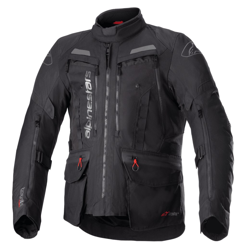 Alpinestars Bogota Pro Drystar Jacket, All-Black Motorcycle Touring Jacket, Gray and Red accents, featuring large chest ventilation panels, waterproof pockets with red pull tabs, high protective collar, and durable textile construction for adventure riding.
