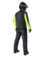 Motorcycle rider seen from the back wearing the Alpinestars Bogotá Pro Drystar® Jacket, Black with bright Yellow Fluo sleeves, matching black pants and helmet, technical all-season adventure gear