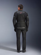 Alpinestars Andes Air Drystar® Jacket and Pants, Black motorcycle touring outfit, rear view of rider, featuring mesh panels, red star logo, and reflective alpinestars branding on the jacket, worn with black gloves and boots.