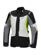 Alpinestars Stella ST-1 Waterproof Jacket, Women's Motorcycle Touring Jacket, Ice Gray, Black, and Fluorescent Yellow, featuring a high collar, front zipper, reinforced shoulders with branding, and adjustable waist straps, adventure touring-inspired design