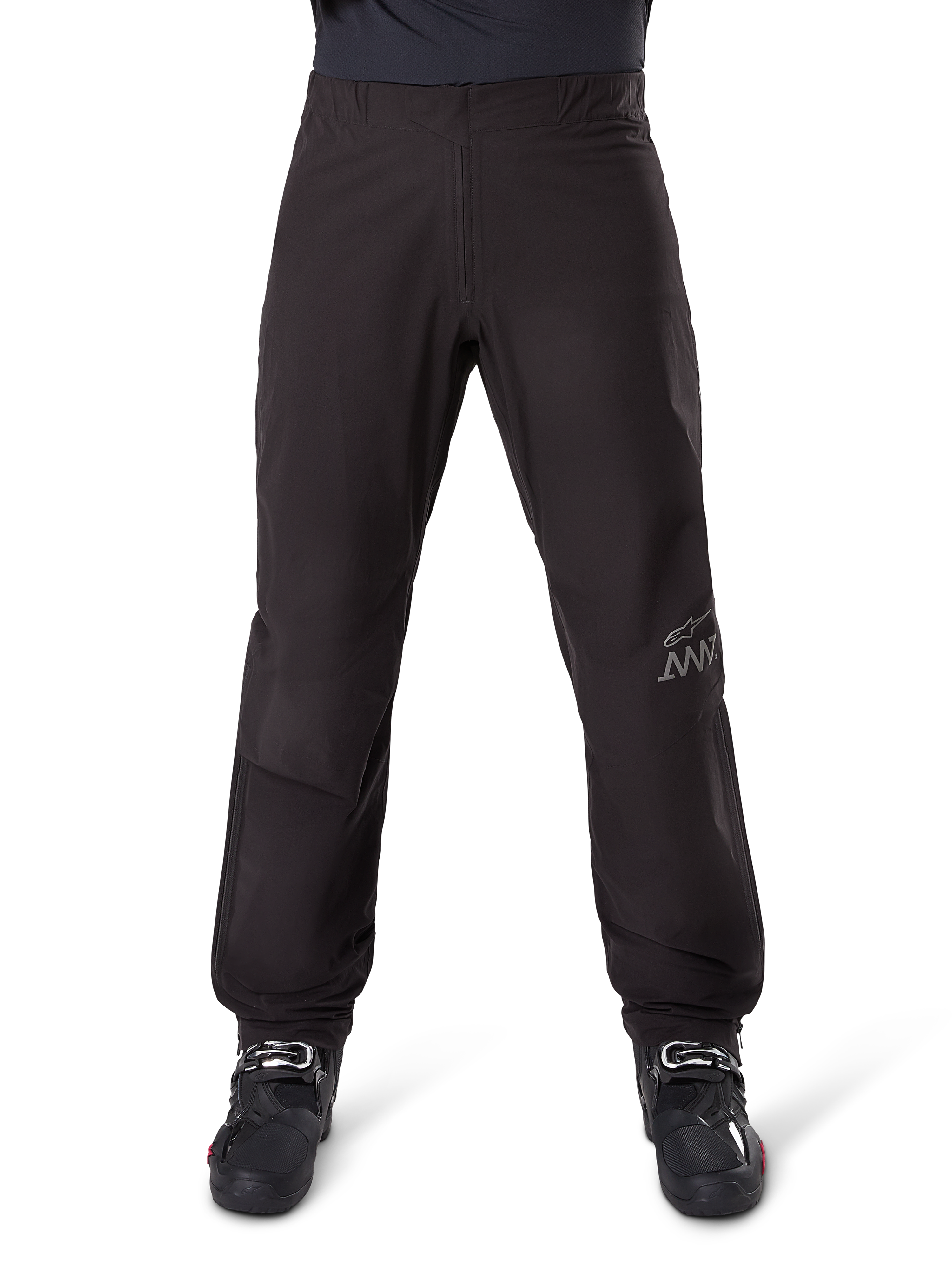 Alpinestars AMT-8 Stretch Drystar® XF Pant Liner, Black, front view worn with black motorcycle boots, featuring grey star logo and AMT branding on the leg, versatile waterproof and windproof motorcycle apparel
