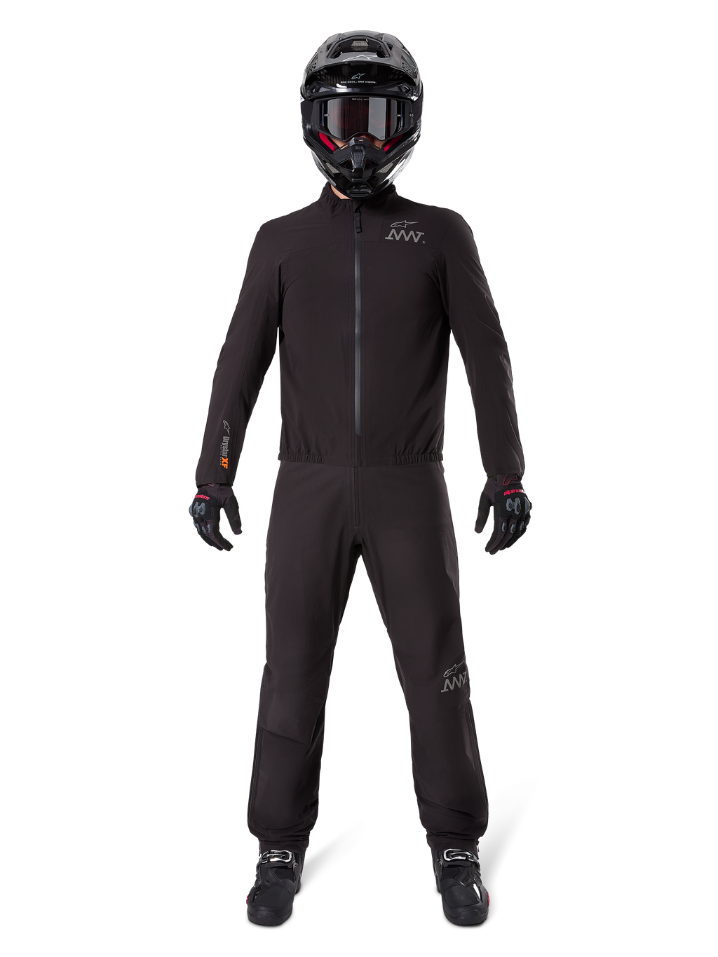 Motorcycle rider wearing Alpinestars AMT-8 Stretch Drystar® XF Pant Liner and matching jacket, all-black waterproof and windproof technical gear, featuring a black helmet, gloves, and boots, sleek adventure touring design.