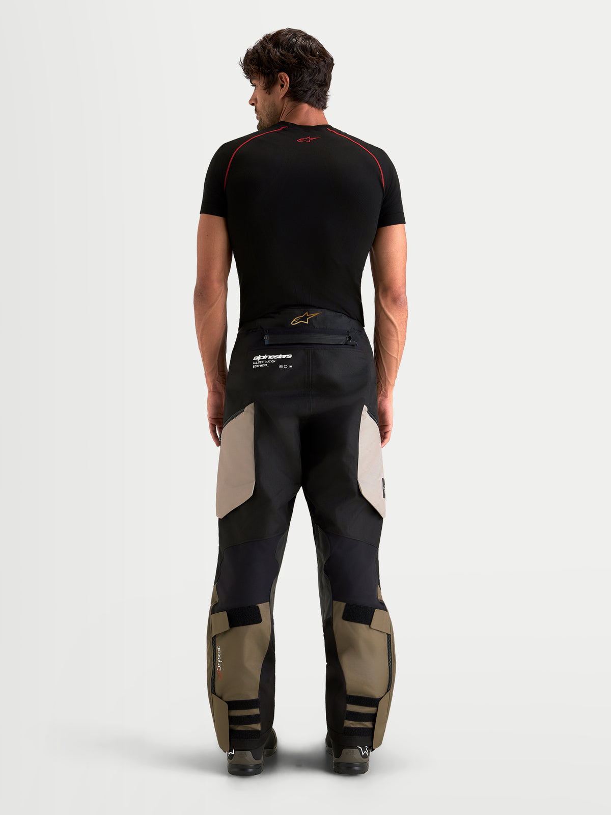 Alpinestars Harok V2 Drystar Pants, men's adventure motorcycle pants, aluminum, walnut, and black, rear view on model showing durable ripstop construction and over-the-boot design