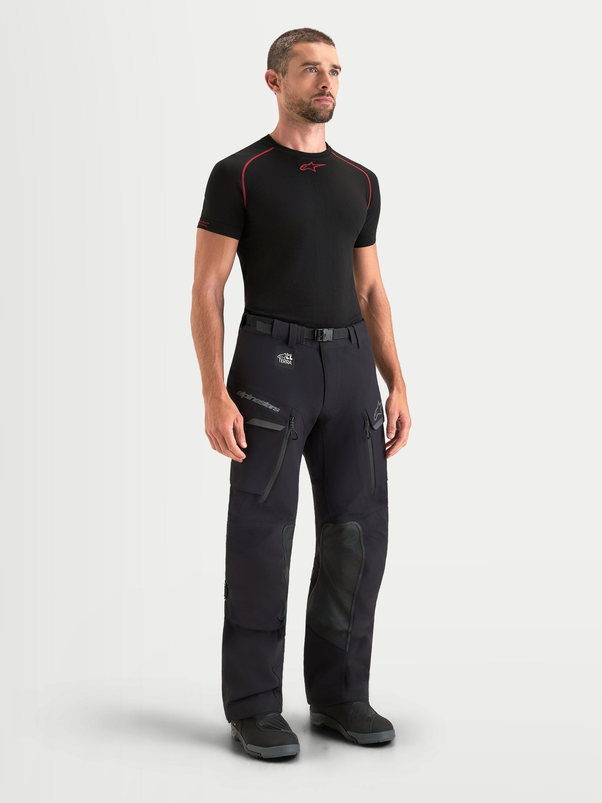 Alpinestars Maxdura Drystar XF Laminated Pants, Men's Adventure Motorcycle Pants in Black and Dark Gray, featuring waterproof 3-layer laminated construction, cargo pockets, and CE certified protection worn by a model