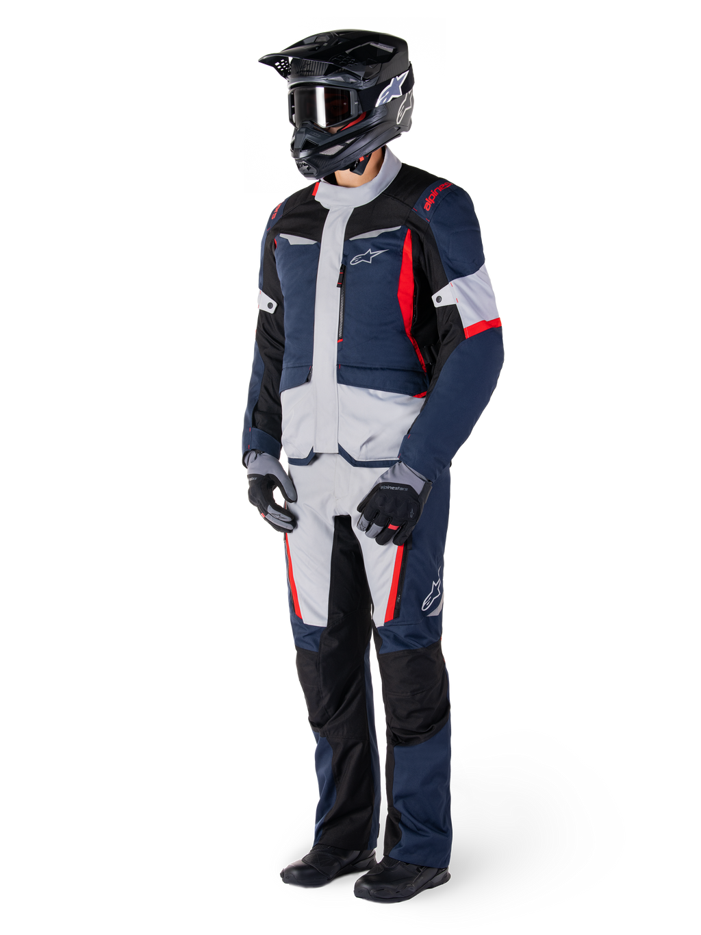 Alpinestars St-1 Waterproof Pants, Adventure Touring Pants, Dark Blue, Black, and Bright Red, worn with a matching touring jacket, black helmet, gloves, and boots, featuring light grey panels, red accents, and Alpinestars branding, designed for all-weather riding.