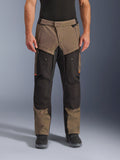 Alpinestars Cusco Drystar® Pants, Adventure Touring Motorcycle Pants, Walnut and Black with orange accents, front view on model, featuring technical textile construction, cargo pockets, and ventilation zippers, worn with black riding boots