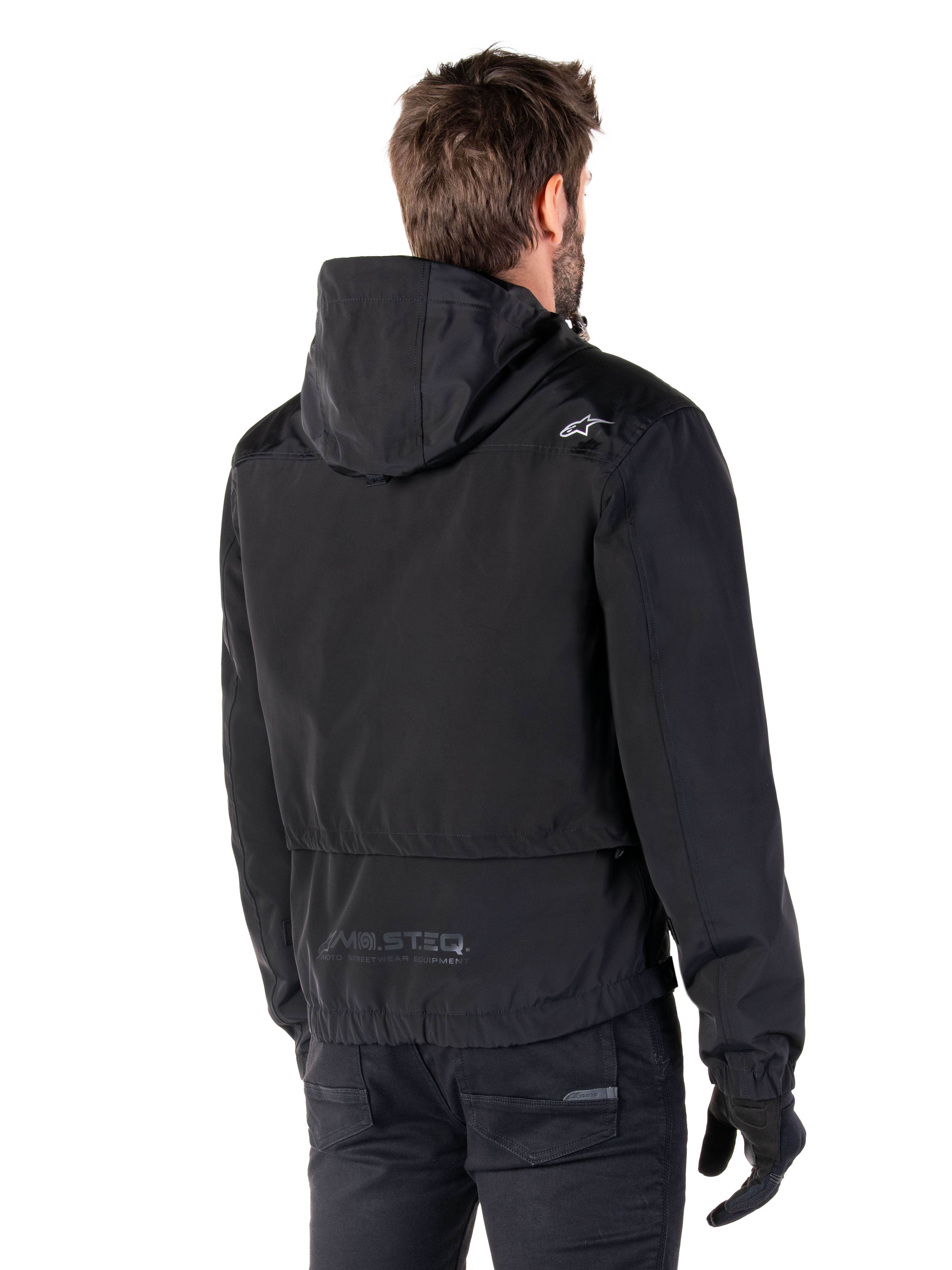 Alpinestars Mootant Waterproof Parka, Black Motorcycle Jacket, Rear view showing hooded design, white logo on shoulder and MO.ST.EQ. reflective branding on lower back, urban contemporary riding gear