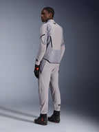 Alpinestars Aeroshell Airflow Jacket in Mid Gray Anthracite, worn with matching pants and black racing gloves, back view showing laser-perforated panels and athletic sport fit, professional motorcycle apparel