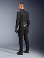 Alpinestars Viper Air V4 Jacket, Black textile motorcycle jacket, rear view on a male model, featuring large tech mesh panels for airflow and a white star logo on the lower back, worn with matching black riding pants and gloves