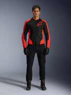 Male model wearing the Alpinestars Viper Air V4 Jacket in Red Fluo and Black, paired with black riding pants, gloves, and boots, featuring breathable mesh panels for ventilation and a bold star logo on the chest, sporty motorcycle road apparel