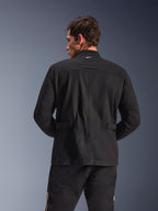 Alpinestars Dice Jacket, Urban Motorcycle Jacket, Black, back view showing pleated shoulders and adjustable waist tabs, field jacket aesthetic with small white logo on collar, protective textile gear for city riding