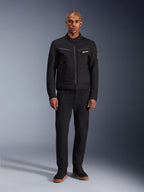 Alpinestars Bruiser Jacket, Black urban motorcycle jacket, worn by model with black pants and high-top sneakers, front view showing zippered chest pockets and embroidered logo, classic workwear-inspired design for everyday commuting