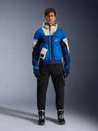 Alpinestars Mogress Air Jacket, Blue Almond urban motorcycle jacket, worn with black pants and boots, featuring a color-blocked blue and cream technical design with utility pockets and a hood, contemporary streetwear-inspired motorcycle apparel