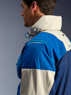 Alpinestars Mogress Air Jacket in Blue Almond, side profile close-up, featuring recycled nylon ripstop fabric, zippered shoulder protector compartment, high collar with integrated hood, urban contemporary motorcycle streetwear