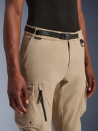 Alpinestars Flex-AST Cargo Pants, Motorcycle Cargo Pants, Light Beige, featuring an integrated black webbing belt with branding, metal D-ring, side zipper pocket, and durable twill fabric for a utilitarian urban riding look