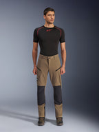 Alpinestars Flex-AST Explorer Pants, Motorcycle Touring Pants, Walnut Brown and Black, featuring reinforced knee panels and zippered thigh pockets, worn with black short-sleeve base layer, full body view