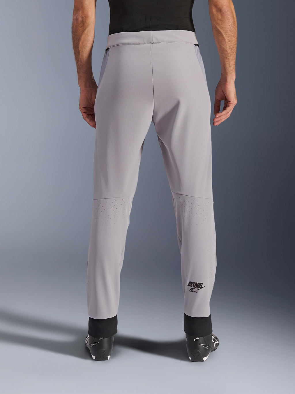 Alpinestars Aeroshell Airflow Pants, Motorcycle Pants, Mid Gray, back view showing laser-perforated zones on the calves and black Astars logo, textile softshell construction with black ankle cuffs and mesh hip panels.