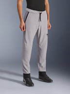 Alpinestars Aeroshell Airflow Pants, Mid Gray, lightweight motorcycle pants with laser-perforated ventilation zones on the thighs and shins, featuring a drawstring elastic waistband and a slim sport fit, styled on a model wearing black riding shoes.