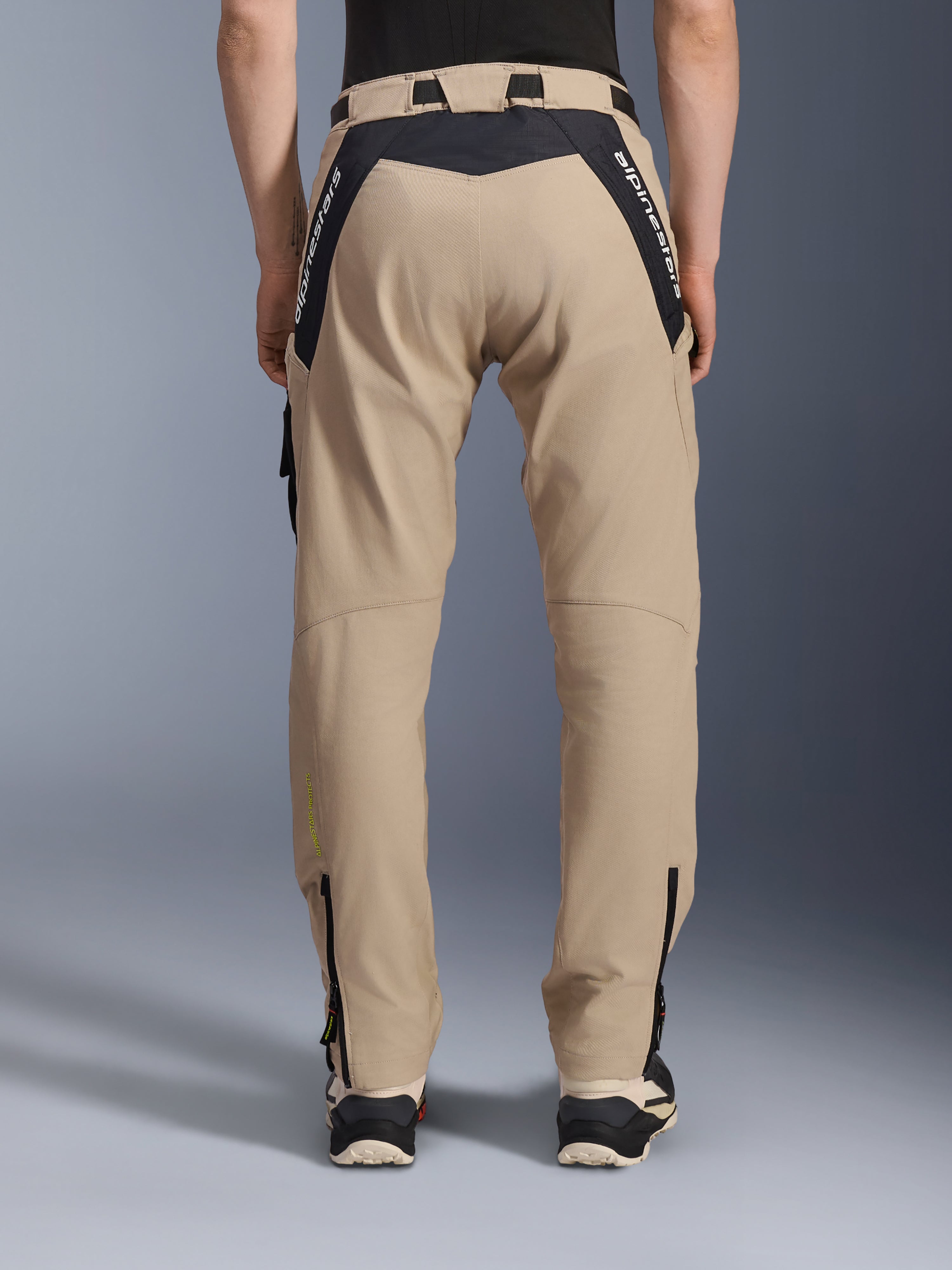 Alpinestars Acteon Hose, Urban-Motorradhose, Sand, Rückansicht mit schwarzen Ripstop-Einsätzen und weißem Branding am Sattel, schmal zulaufende Passform mit Reißverschlüssen an den Beinabschlüssen, moderne Straßenausrüstung