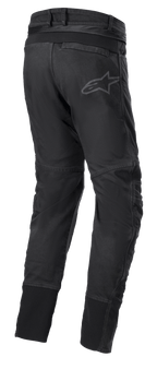 Alpinestars SP Pro Pants, Technical Motorcycle Sport Pants in Black, rear view showing waist connection zipper, RIDEKNIT stretch inserts on the back yoke and calves, and subtle logo branding.